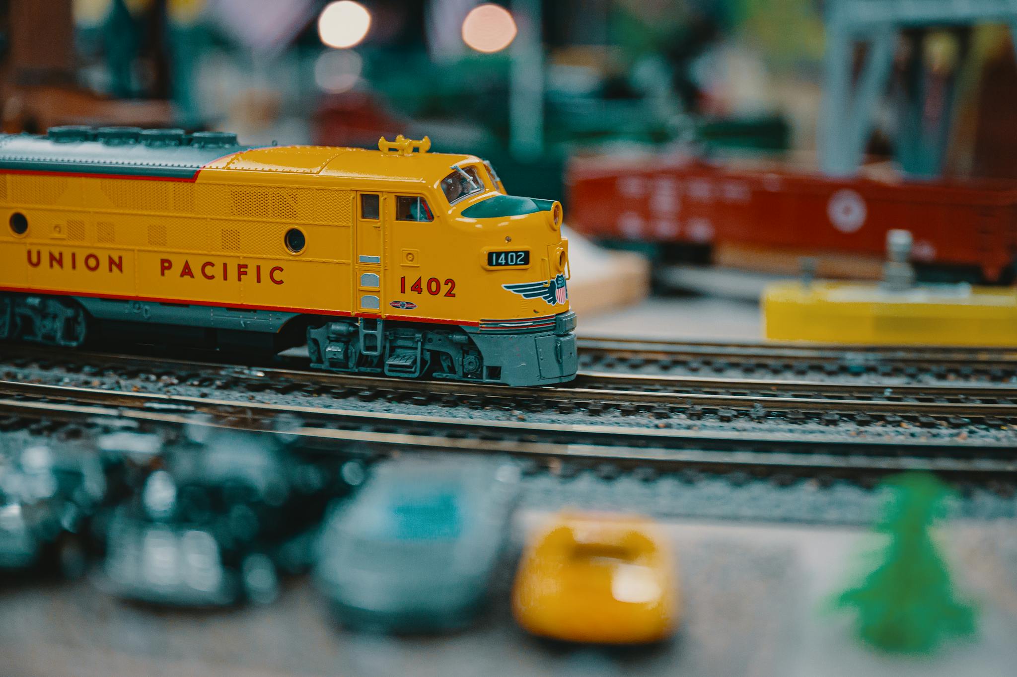 Vibrant Union Pacific model train on a miniature railway track indoors.